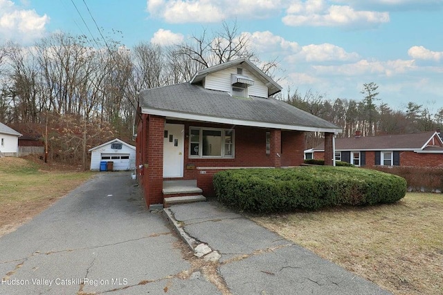 view of front of property featuring a garage and an outdoor structure