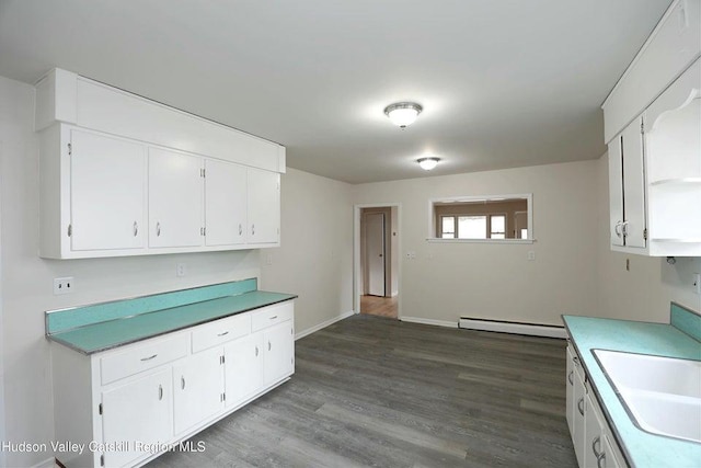 kitchen featuring white cabinetry, a baseboard radiator, sink, and dark hardwood / wood-style floors