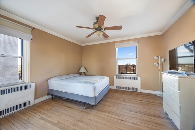 bedroom with radiator, ceiling fan, ornamental molding, and light wood-type flooring