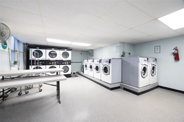 clothes washing area with washing machine and clothes dryer and stacked washer / drying machine