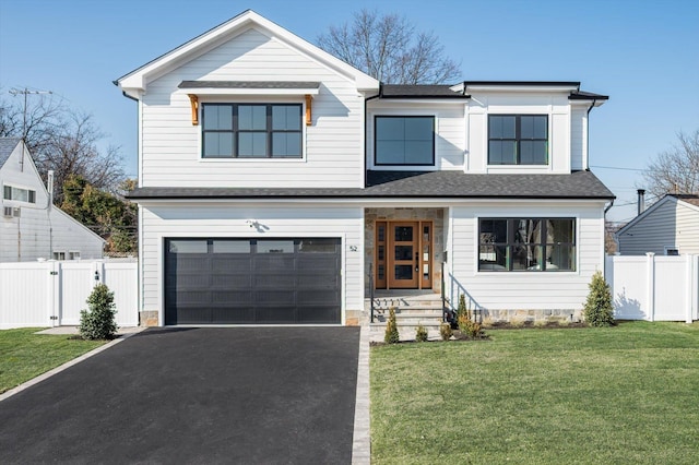 view of front facade featuring a front yard and a garage