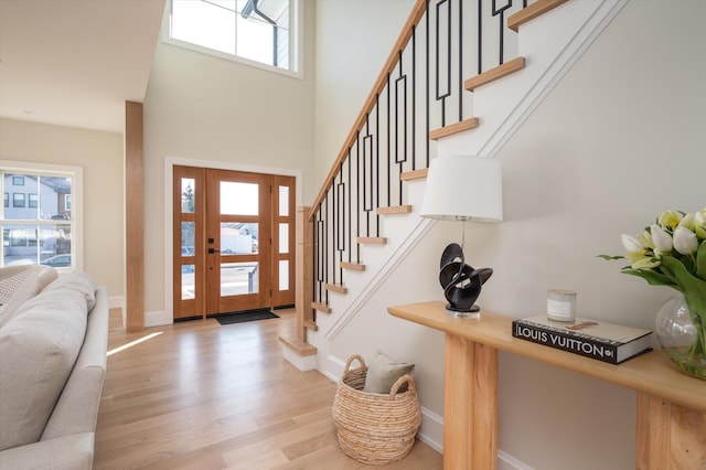 foyer with a high ceiling and light hardwood / wood-style flooring