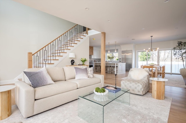 living room featuring a notable chandelier and hardwood / wood-style flooring