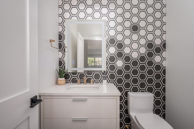 bathroom featuring toilet and vanity