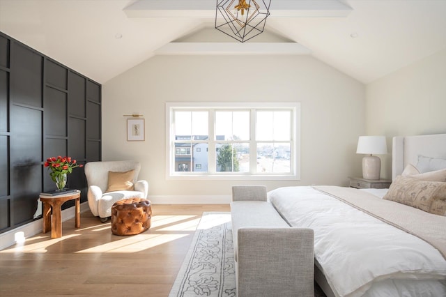 bedroom featuring vaulted ceiling with beams, a chandelier, and hardwood / wood-style flooring