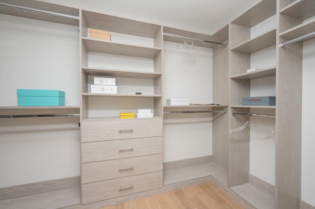 spacious closet featuring light wood-type flooring