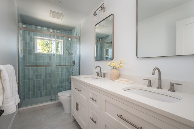 bathroom with toilet, vanity, and a shower with door