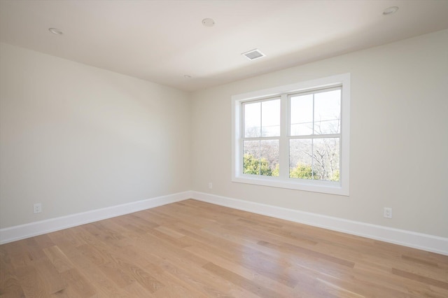 spare room with light hardwood / wood-style flooring