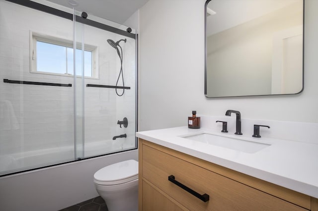 full bathroom featuring toilet, bath / shower combo with glass door, and vanity