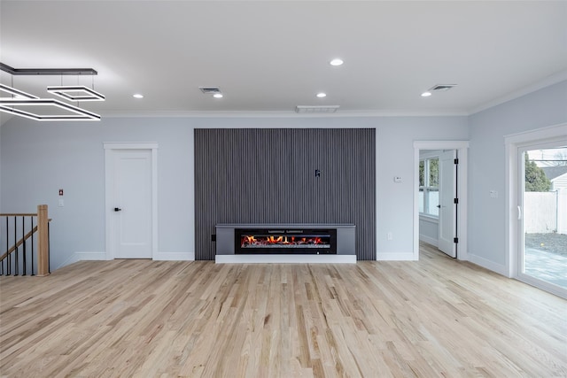 unfurnished living room featuring recessed lighting, wood finished floors, visible vents, and crown molding