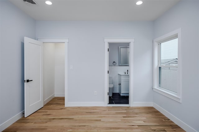 unfurnished bedroom featuring light wood-style floors, recessed lighting, visible vents, and baseboards