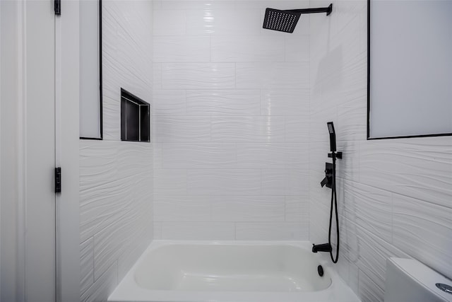 bathroom featuring bathtub / shower combination and toilet