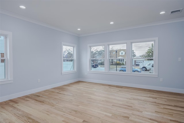 spare room featuring baseboards, visible vents, and ornamental molding