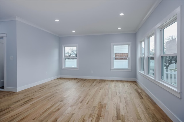 unfurnished room featuring ornamental molding, plenty of natural light, and baseboards