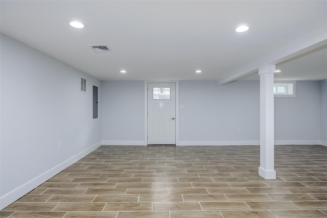 basement with wood tiled floor, visible vents, plenty of natural light, and recessed lighting