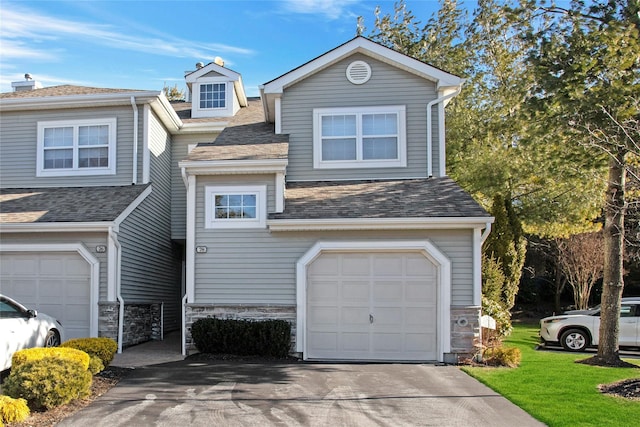 view of front facade with a front yard and a garage