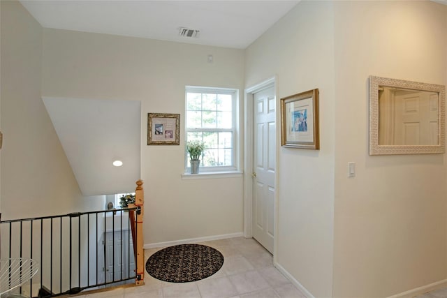 doorway to outside featuring light tile patterned flooring