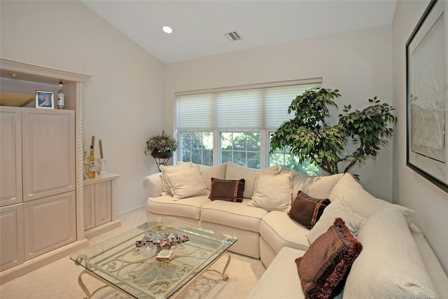 living room with vaulted ceiling and light carpet