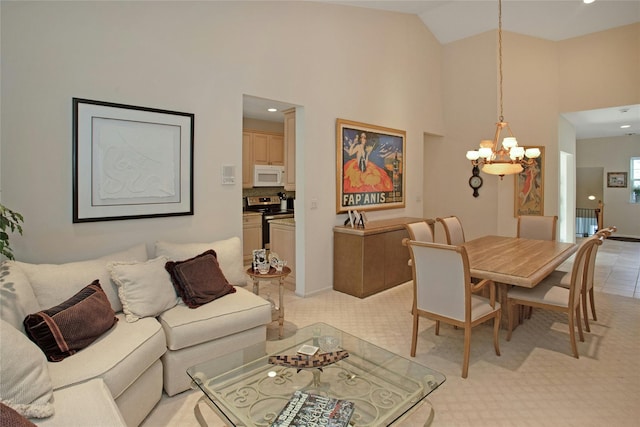 carpeted dining room with high vaulted ceiling and a chandelier