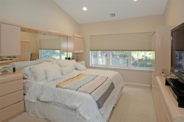 bedroom featuring lofted ceiling and light colored carpet