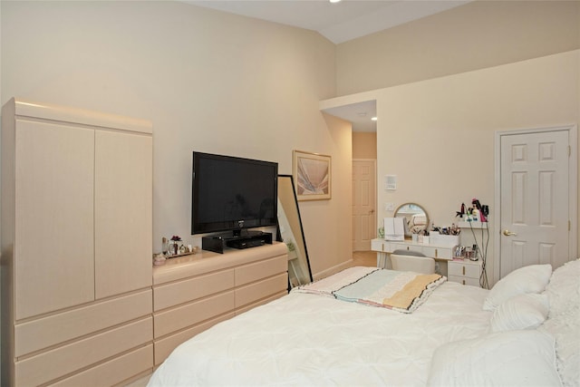 bedroom with lofted ceiling and a closet