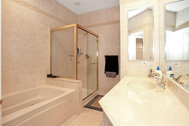 bathroom with tile walls, vanity, tile patterned floors, and shower with separate bathtub