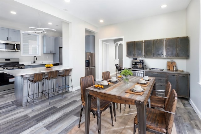 dining space with sink and hardwood / wood-style flooring