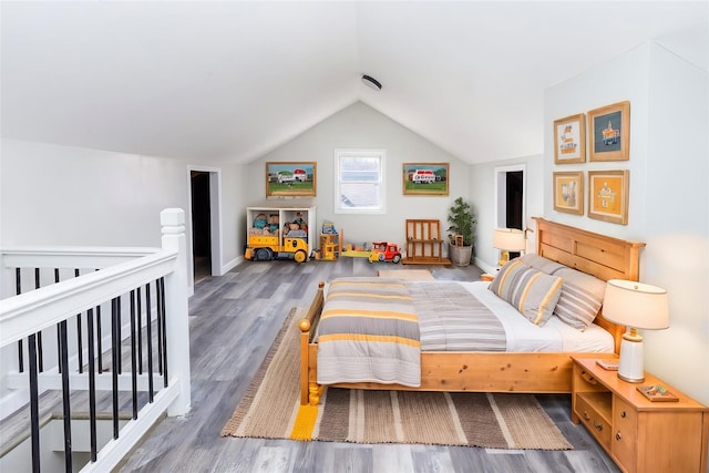 bedroom with wood-type flooring and lofted ceiling