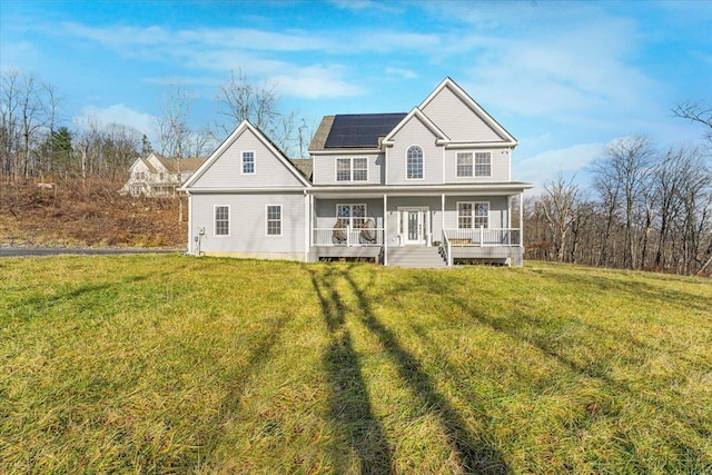 back of house featuring solar panels, a yard, and a porch