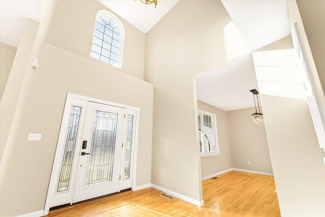 entrance foyer with light hardwood / wood-style floors and an inviting chandelier