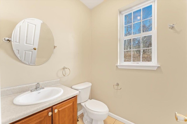 bathroom with tile patterned flooring, vanity, and toilet