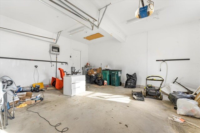 garage featuring a garage door opener and heating unit