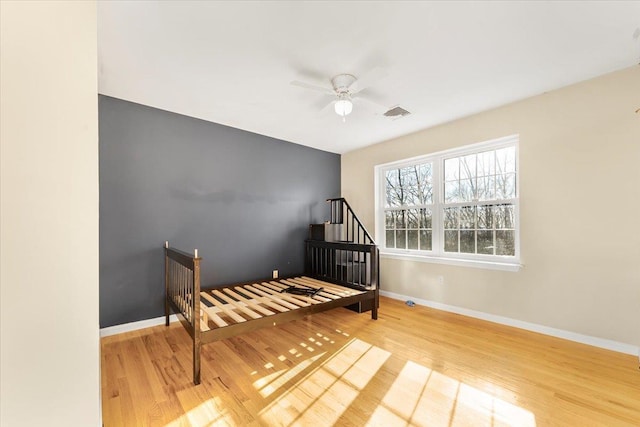 bedroom with ceiling fan and light wood-type flooring