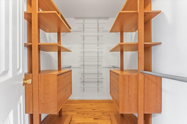 spacious closet with light hardwood / wood-style flooring