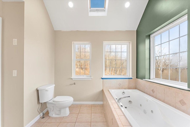 bathroom with toilet, tile patterned floors, lofted ceiling with skylight, and tiled tub