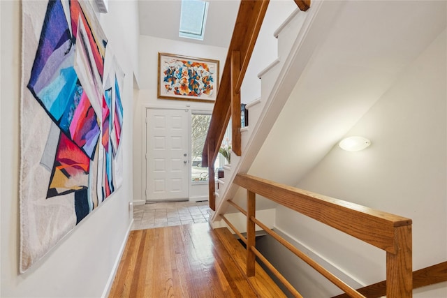 interior space with hardwood / wood-style floors and a skylight