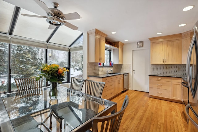 kitchen featuring light brown cabinetry, light hardwood / wood-style floors, appliances with stainless steel finishes, and sink