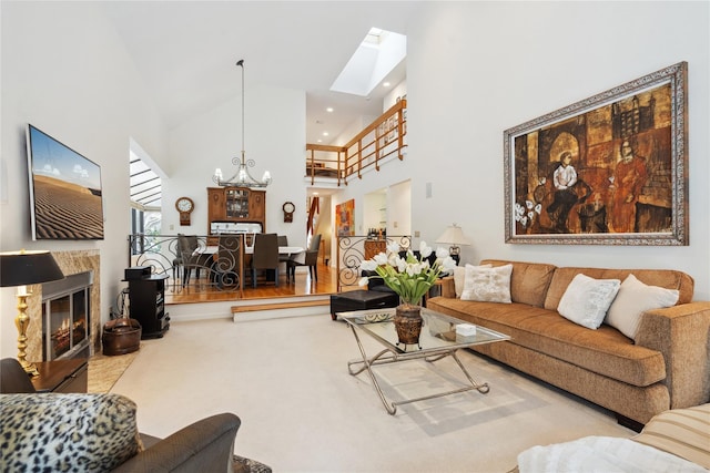 living room featuring a skylight, high vaulted ceiling, and an inviting chandelier