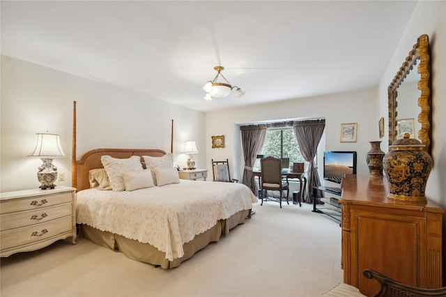 bedroom with a notable chandelier and light carpet