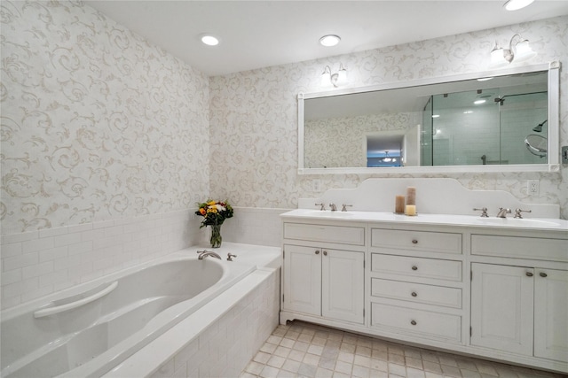 bathroom featuring plus walk in shower, vanity, and tile patterned floors