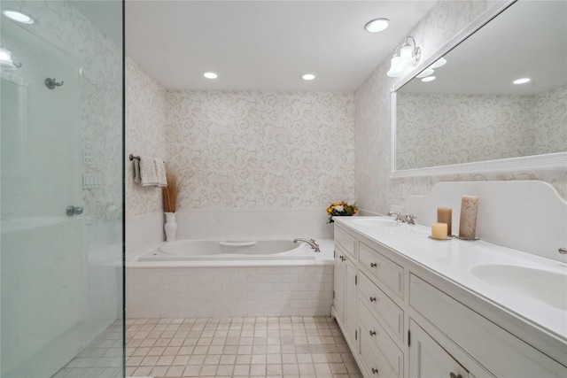 bathroom featuring plus walk in shower, vanity, and tile patterned flooring