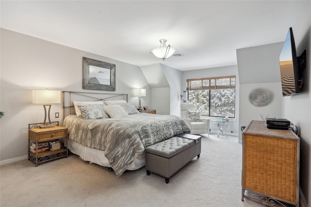 bedroom with carpet and lofted ceiling