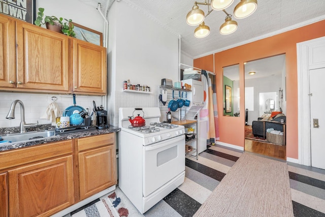 kitchen with sink, a notable chandelier, a textured ceiling, white range with gas cooktop, and ornamental molding