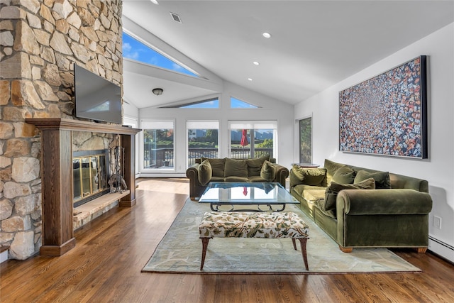 living room with hardwood / wood-style floors, lofted ceiling, a fireplace, and a baseboard radiator