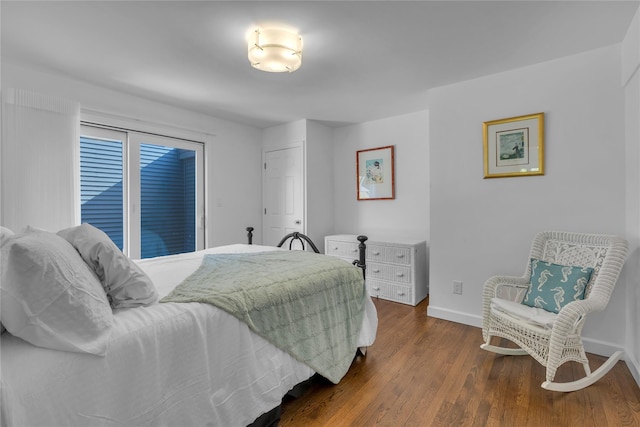 bedroom with dark hardwood / wood-style floors