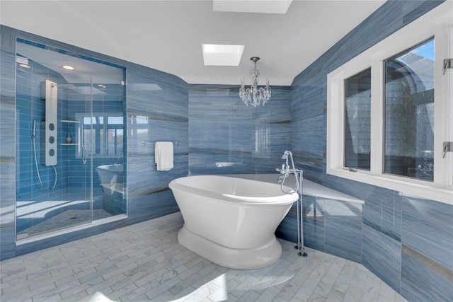 bathroom with tile patterned flooring, tile walls, independent shower and bath, and a skylight