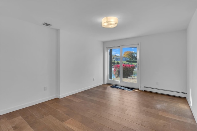 spare room with light hardwood / wood-style floors and a baseboard radiator