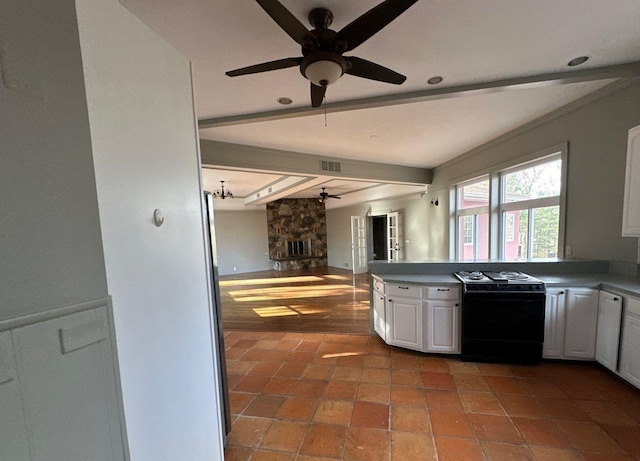 kitchen featuring white cabinets, ceiling fan with notable chandelier, tile patterned floors, black range with electric cooktop, and beam ceiling