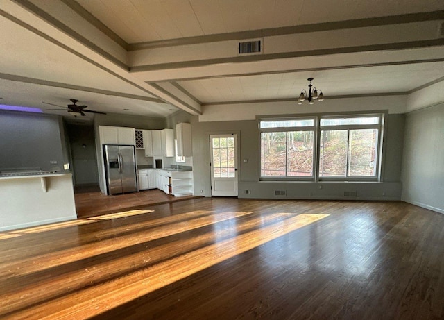 unfurnished living room with dark hardwood / wood-style flooring, beamed ceiling, and ceiling fan with notable chandelier