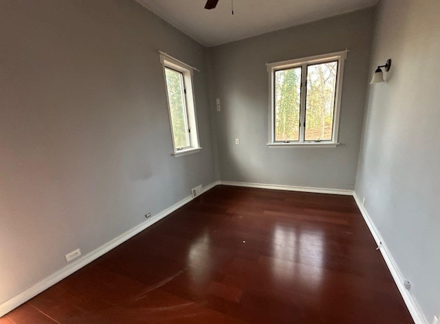 spare room featuring dark hardwood / wood-style floors and ceiling fan